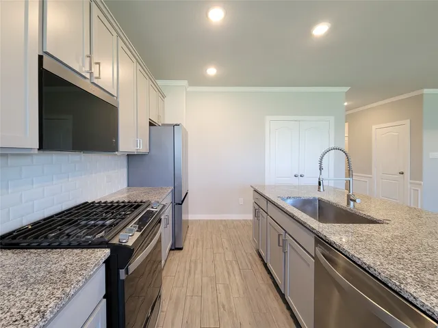 a kitchen with sink a microwave and stove