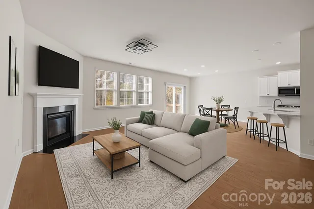 a living room with furniture fireplace and flat screen tv