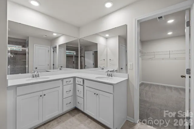 a bathroom with a double vanity sink and mirror