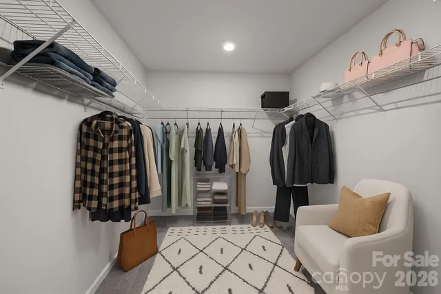 a view of walk in closet with clothes and shoes