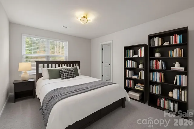 a bedroom with a bed and a book shelf