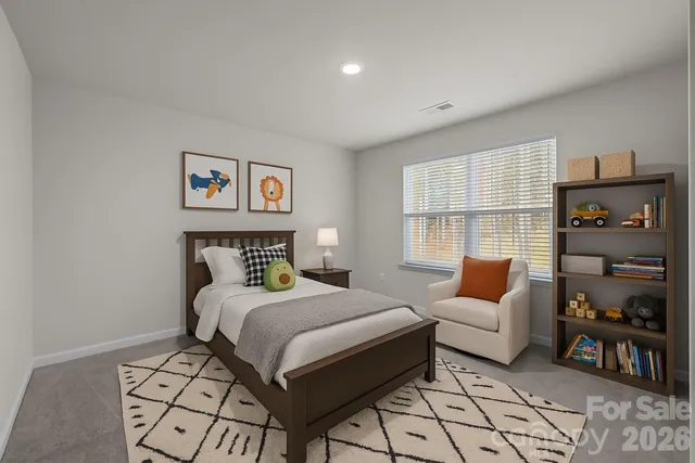 a bedroom with a bed and a couch