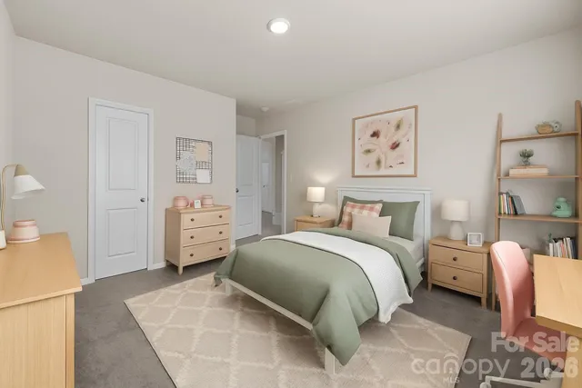 a spacious bedroom with a bed and a cabinets