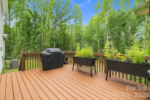 a view of a deck with wooden floor and outdoor seating