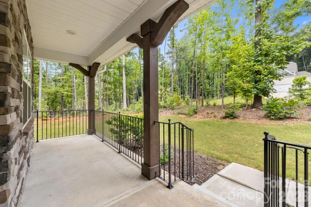 a view of a porch with a floor to ceiling window and a big yard