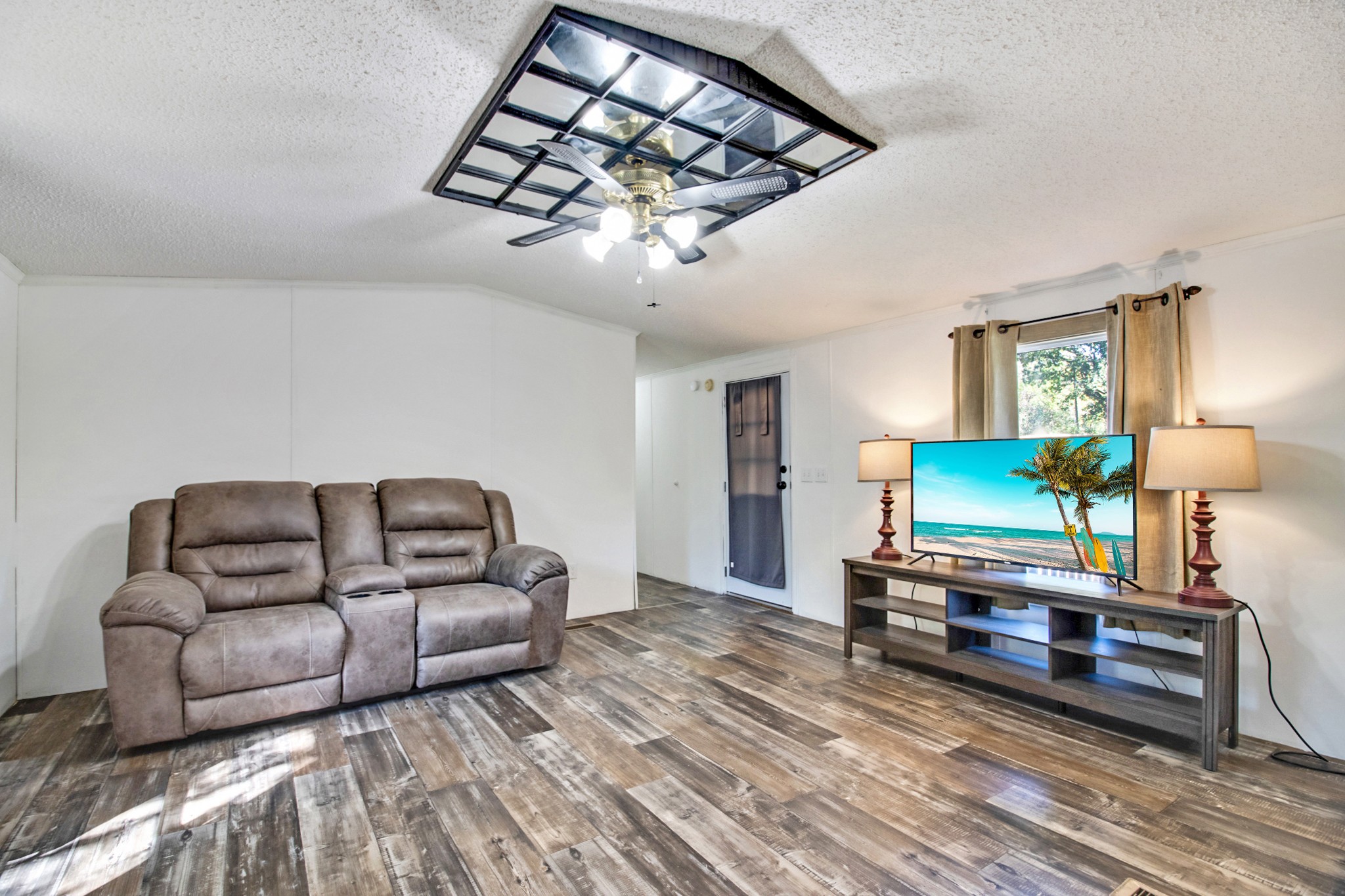 131 Maynard Avenue Jamestown, TN 38556 - Photo 15 of 59 a living room with furniture a chandelier and a flat screen tv