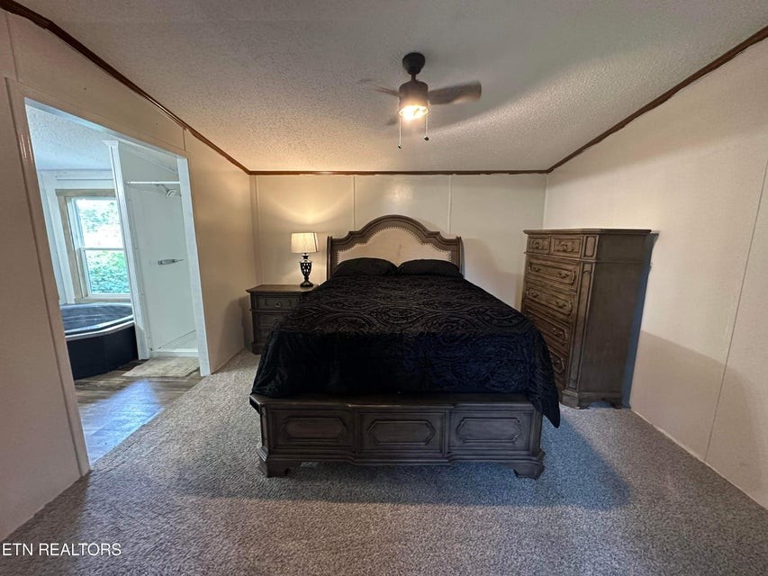 131 Maynard Avenue Jamestown, TN 38556 - Photo 7 of 59 a bed sitting in a room next to a lamp