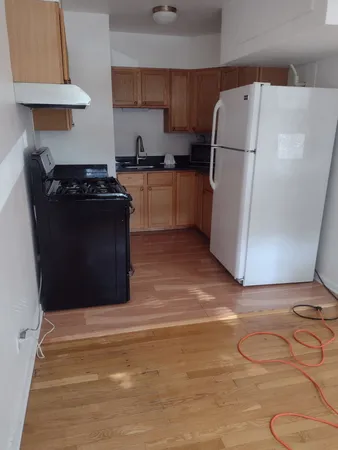 a kitchen with a refrigerator and a stove