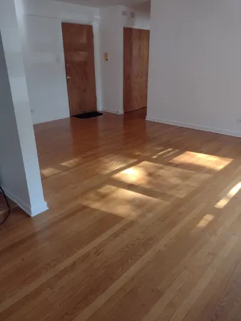 a view of an empty room and wooden floor