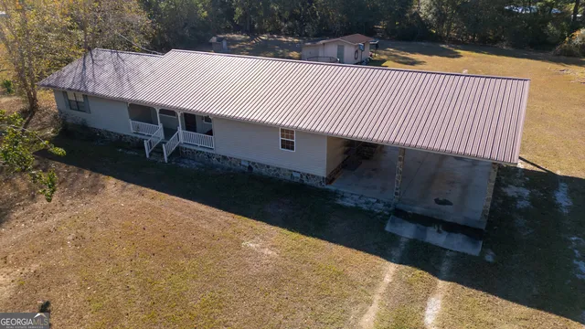 a view of a roof deck with wooden fence and plants