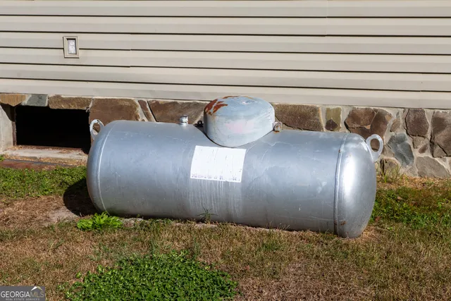 a view of a wooden house with a yard