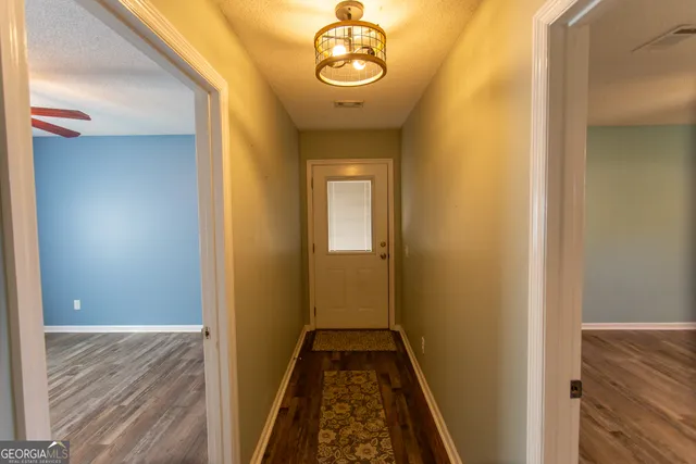 a view of walk in closet with wooden floor
