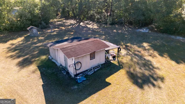 a aerial view of a house with a yard