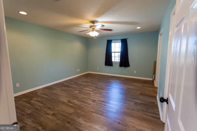 a view of walk in closet with wooden floor