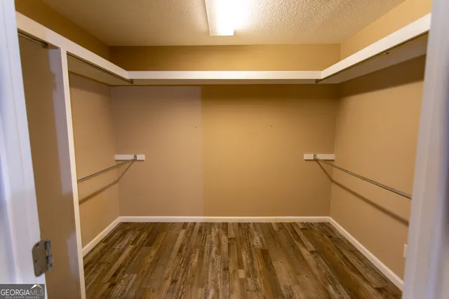 a kitchen with stainless steel appliances granite countertop a stove and a wooden floors