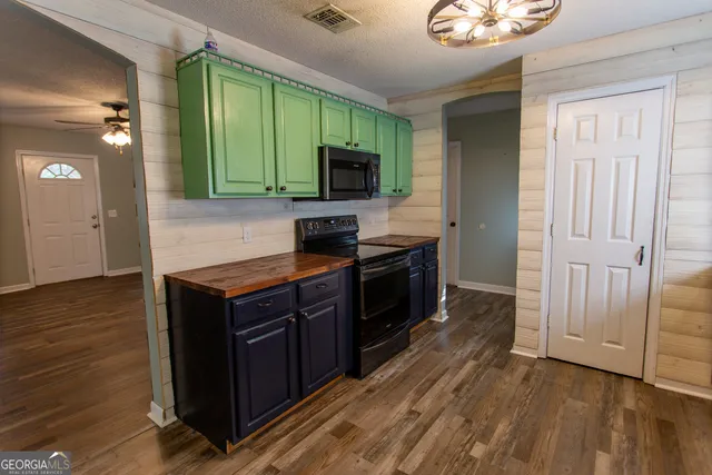 a kitchen with granite countertop wood cabinets and stainless steel appliances