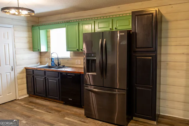 a kitchen with granite countertop a stove top oven microwave and cabinets