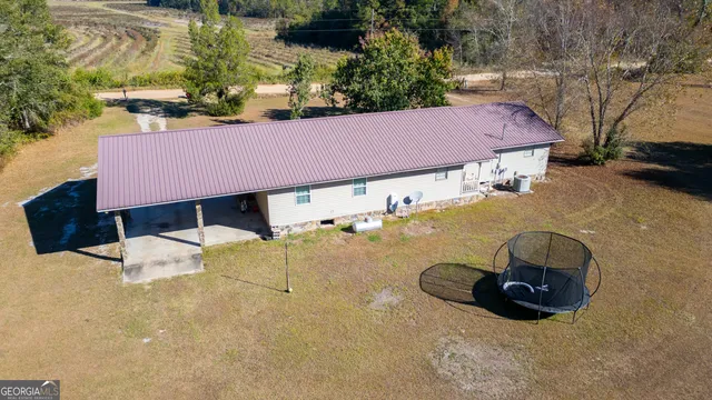 a view of a wooden house with a yard