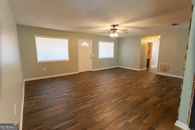 a view of a room with wooden floor
