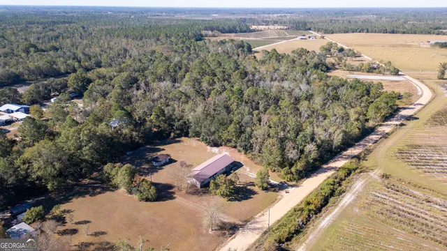 an aerial view of a house with a yard and lake view