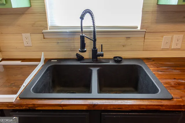 a kitchen sink with granite countertop