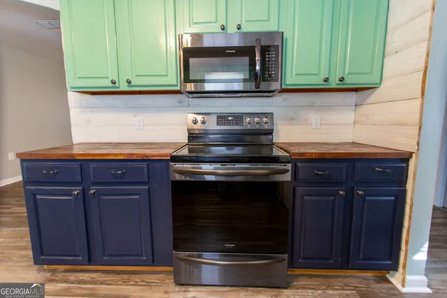 a kitchen with granite countertop wood cabinets and stainless steel appliances