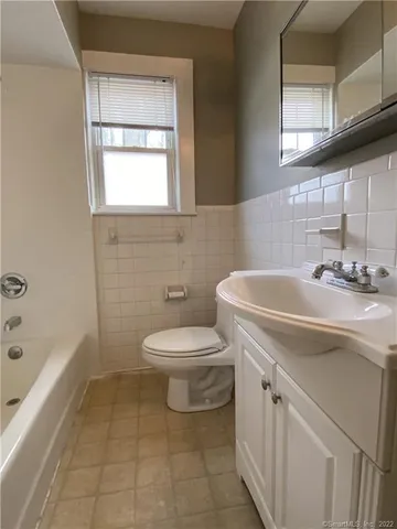 a bathroom with a sink a toilet and bathtub