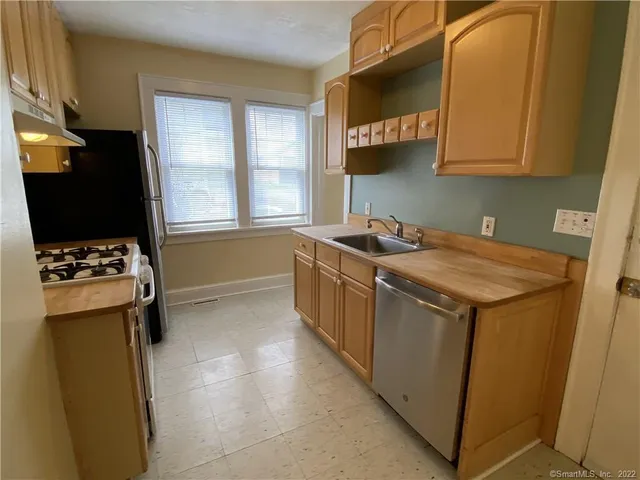 a utility room with sink dryer and washer