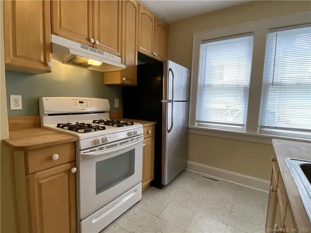 a kitchen with a stove and a refrigerator