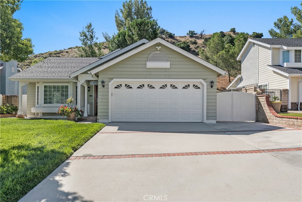 28248 Branch Road Castaic, CA 91384 - Photo 1 of 1 a view of a white house with a small yard and potted plants