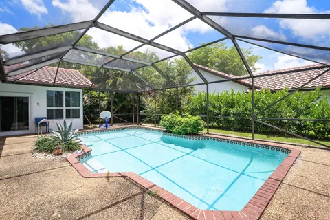 a view of a backyard with a patio and a garden
