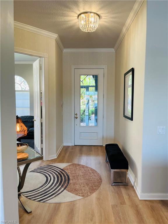 5477 Freeport Lane Naples, FL 34119 - Photo 4 of 36 a view of a livingroom with furniture and front door