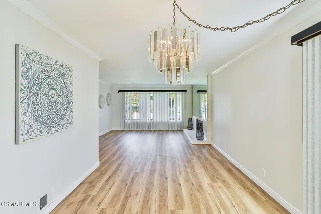 a kitchen with granite countertop white cabinets and sink