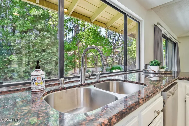 a spacious en suite bathroom with double sink and a mirror
