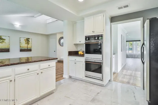 a bathroom with double vanity sink and a mirror
