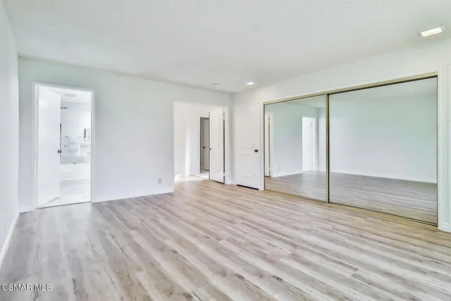 a bathroom with a granite countertop sink a toilet and a mirror
