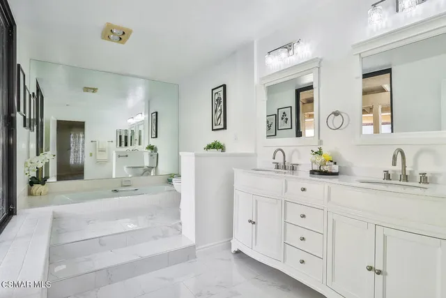 a view of a hallway with wooden floor and windows