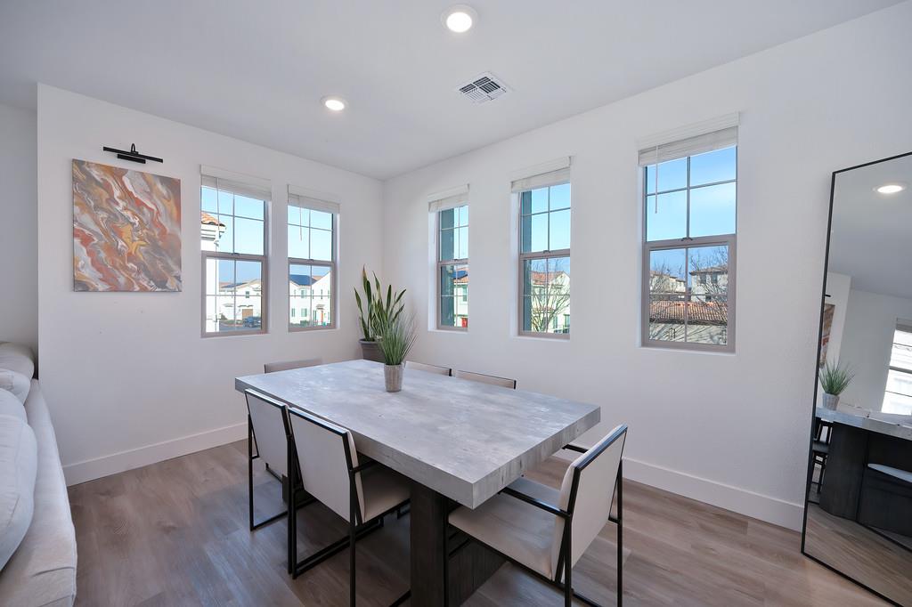 5301 East Commerce Way, Unit 32101 Sacramento, CA 95835 - Photo 11 of 41 a view of a dining room with furniture window and wooden floor
