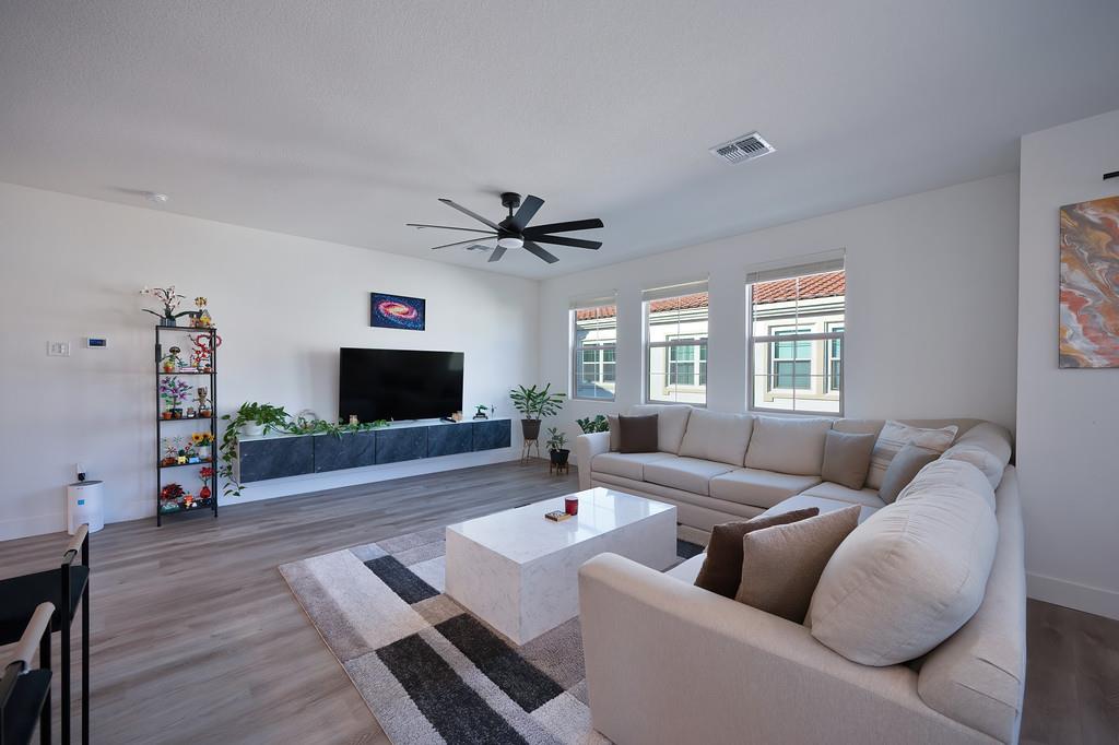 5301 East Commerce Way, Unit 32101 Sacramento, CA 95835 - Photo 12 of 41 a living room with furniture and a flat screen tv