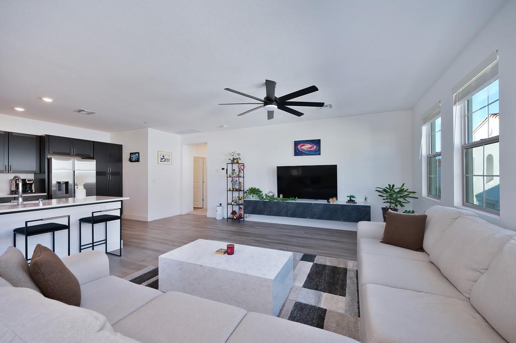 5301 East Commerce Way, Unit 32101 Sacramento, CA 95835 - Photo 13 of 41 a living room with furniture and a flat screen tv