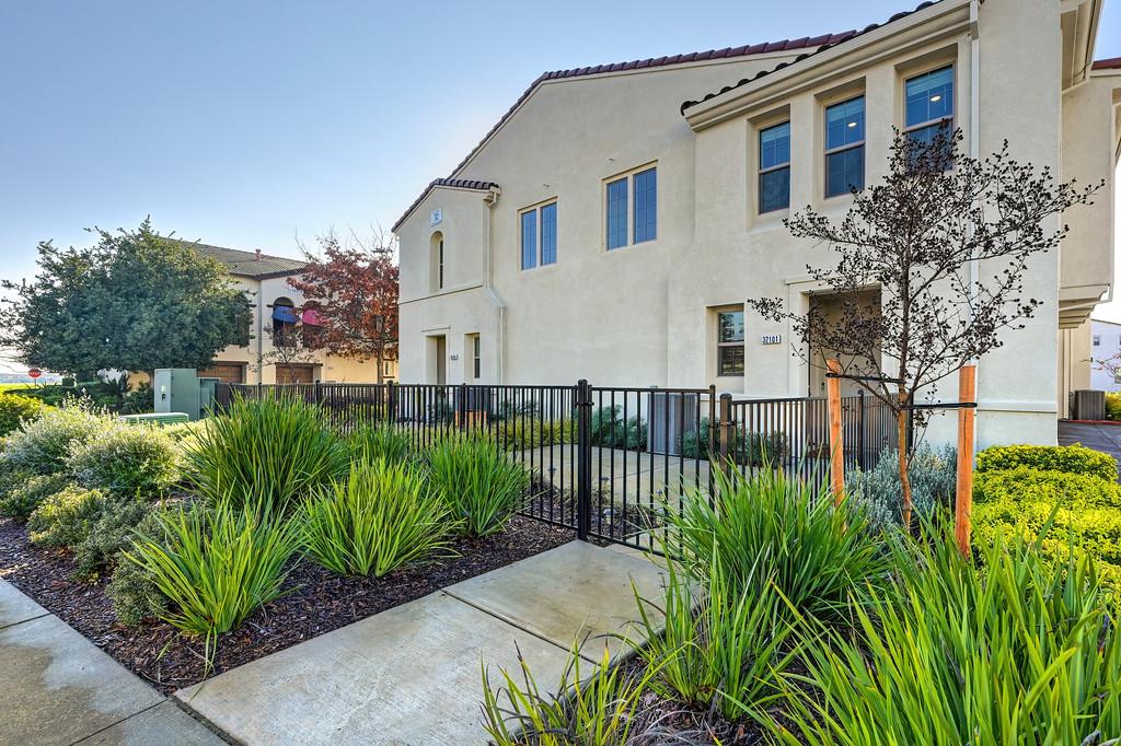 5301 East Commerce Way, Unit 32101 Sacramento, CA 95835 - Photo 2 of 41 a front view of a house with a garden
