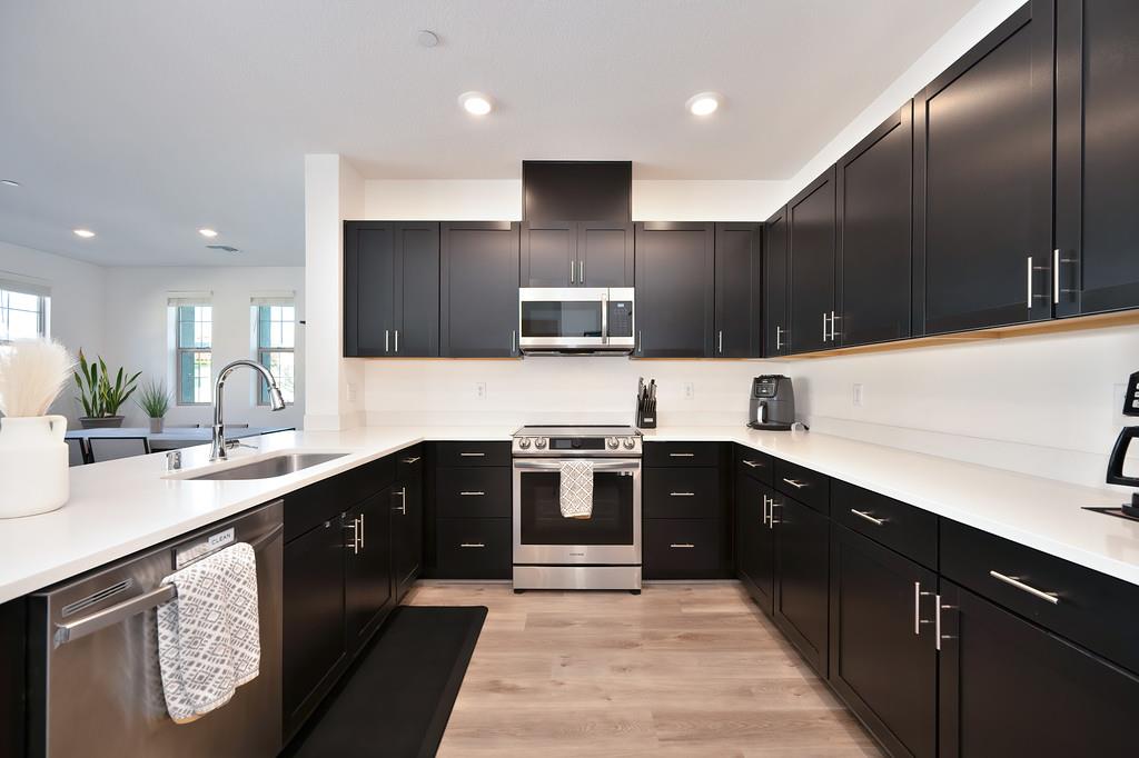 5301 East Commerce Way, Unit 32101 Sacramento, CA 95835 - Photo 22 of 41 a kitchen with stainless steel appliances granite countertop a sink stove and refrigerator