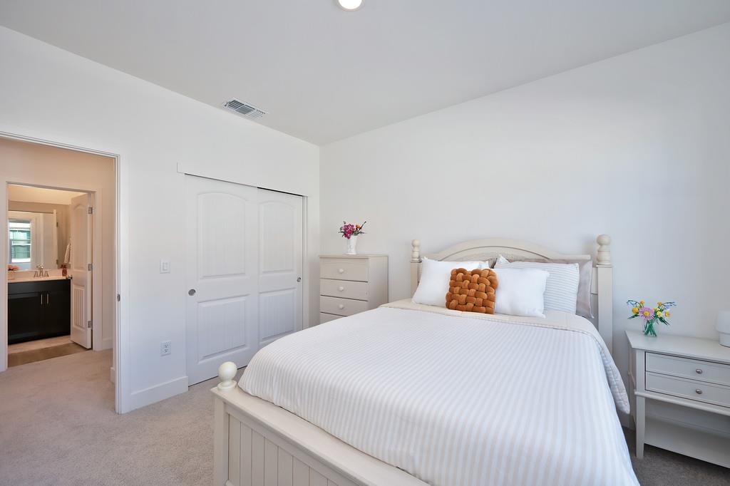 5301 East Commerce Way, Unit 32101 Sacramento, CA 95835 - Photo 29 of 41 a bedroom with a bed and a closet
