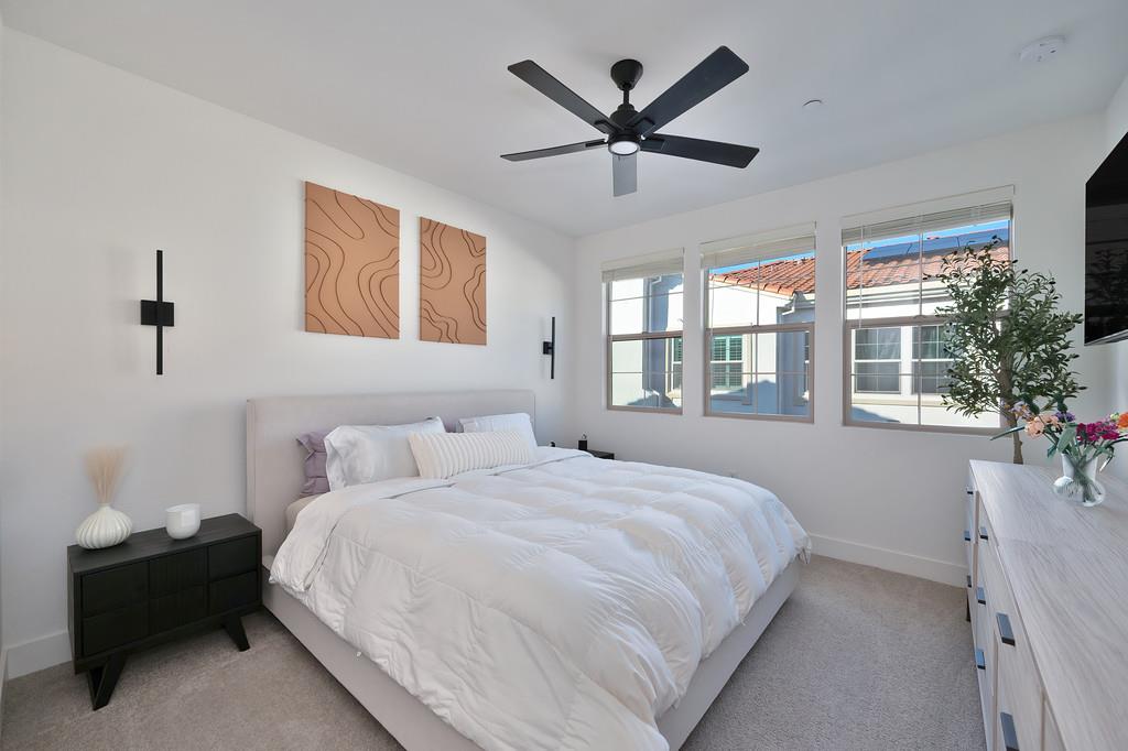 5301 East Commerce Way, Unit 32101 Sacramento, CA 95835 - Photo 30 of 41 a bedroom with a large bed and a large window