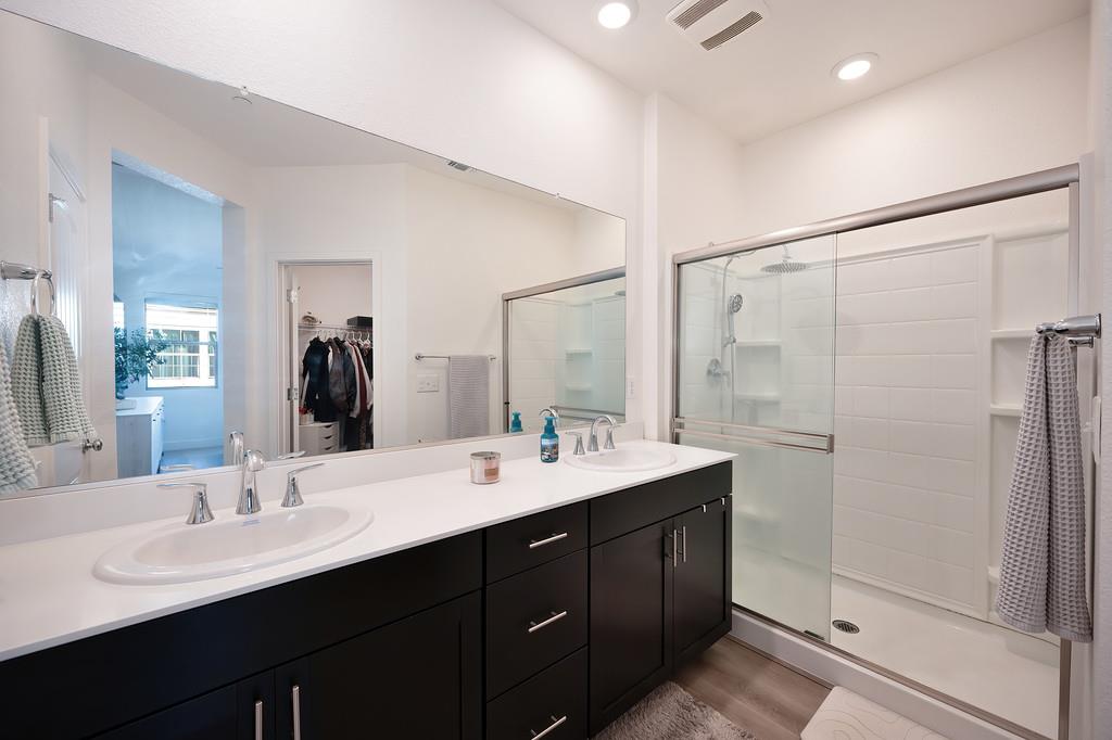 5301 East Commerce Way, Unit 32101 Sacramento, CA 95835 - Photo 35 of 41 a bathroom with double sink and a mirror