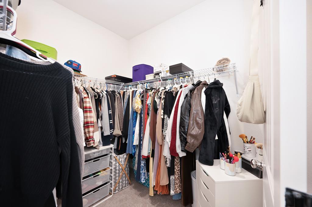 5301 East Commerce Way, Unit 32101 Sacramento, CA 95835 - Photo 36 of 41 a view of walk in closet with clothes and shoes