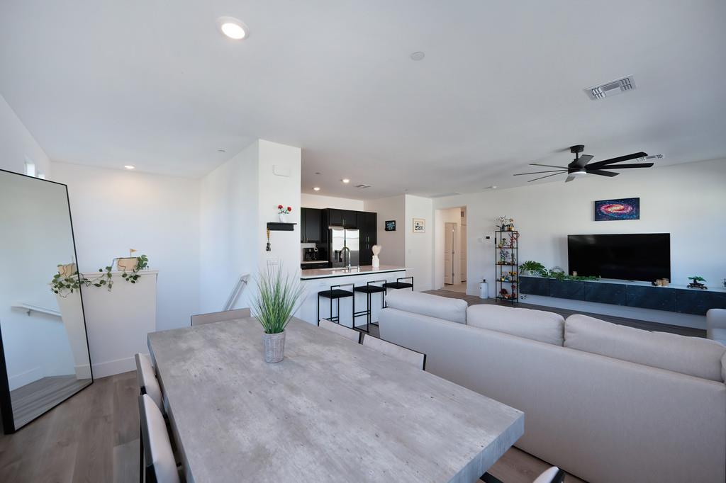 5301 East Commerce Way, Unit 32101 Sacramento, CA 95835 - Photo 9 of 41 a living room with furniture and a flat screen tv