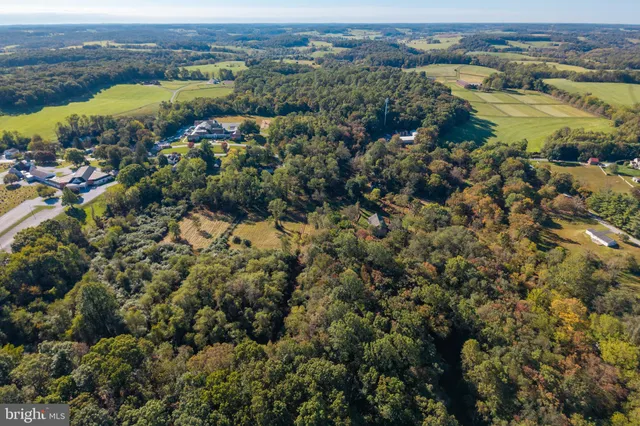 an aerial view of residential houses with city view