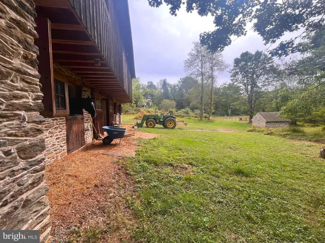 a view of a backyard with sitting area and garden