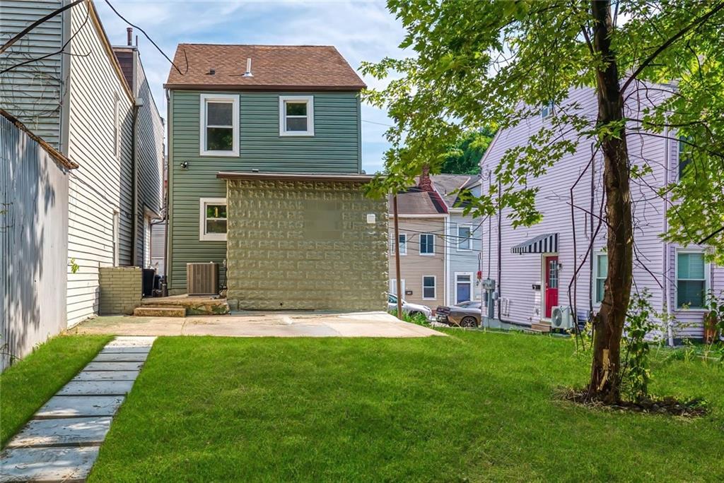 117 Fountain Street Pittsburgh, PA 15212 - Photo 19 of 21 Back of the home with grass and patio stones.